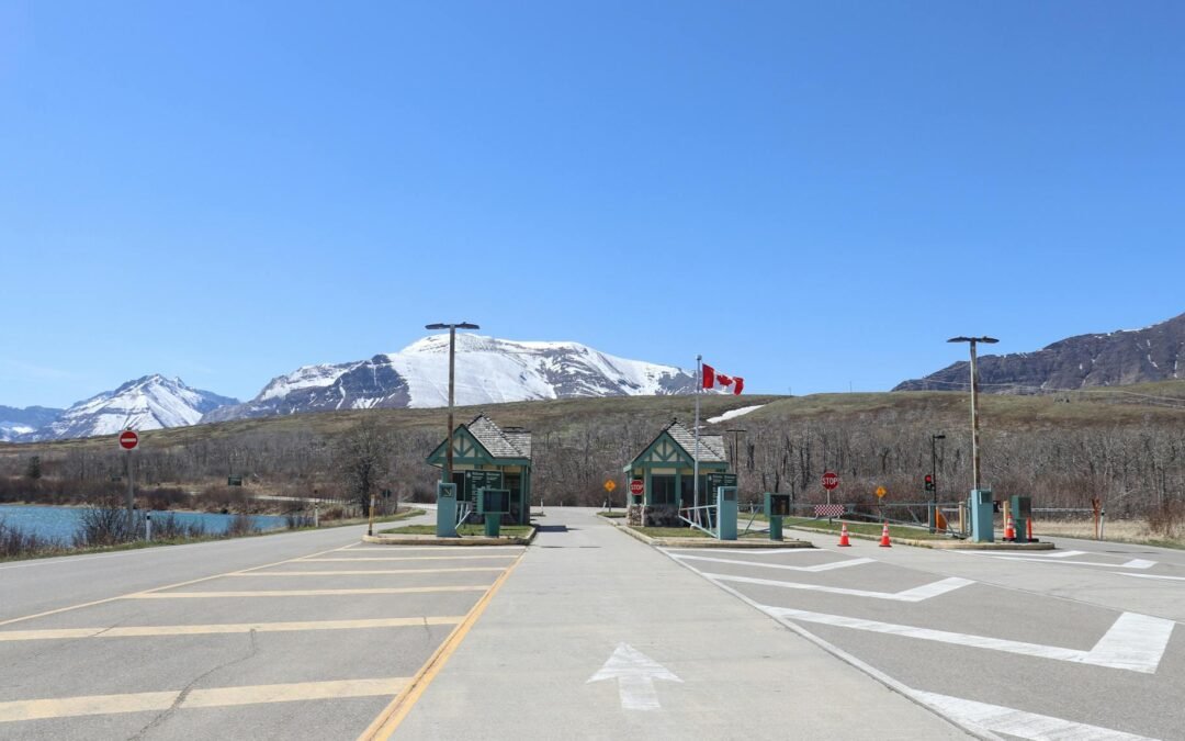 Border crossing in Canada, highlighting immigration pathways amidst scenic mountains and clear skies.