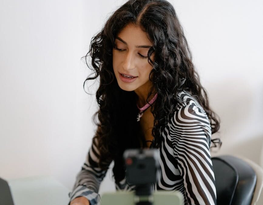 Young entrepreneur engaging in a live stream, discussing business strategies with confidence.