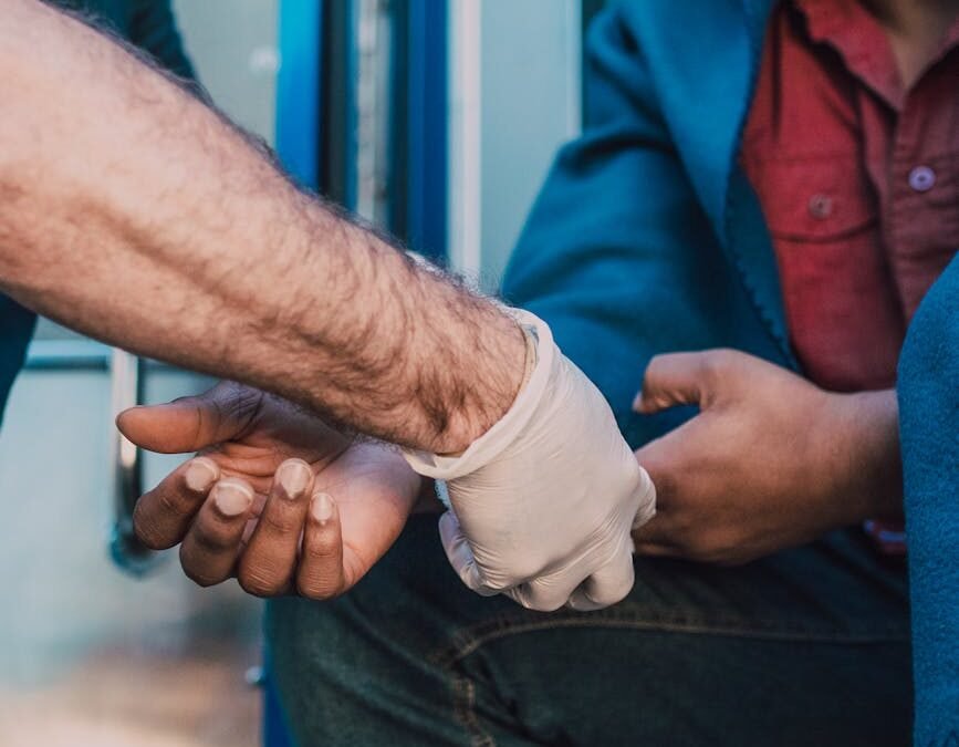 Health care aide providing support to a patient in emergency care setting.