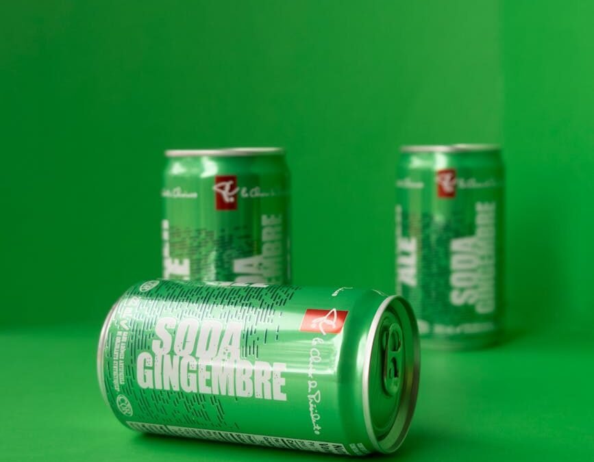 Green soda cans on vibrant background, symbolizing refreshing Canadian lifestyle for PR pathways.