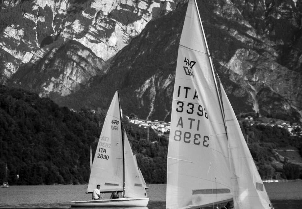 Sailboats on a lake with mountains, symbolizing opportunities like Express Entry ITAs.