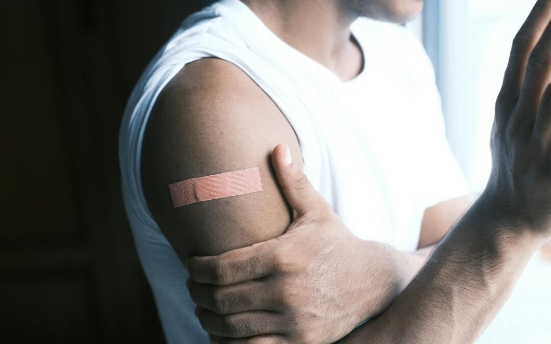 Person with a bandage on their arm, illustrating common health care aide scenarios.