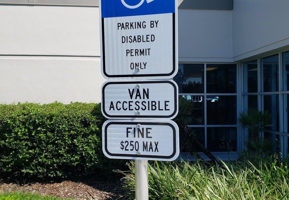 Handicap parking sign, highlighting accessible permits in Canada for work permit applicants.