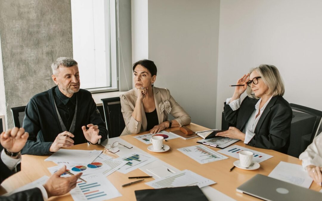 Business professionals discussing strategies for improving client engagement in a meeting.