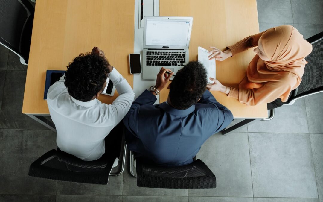 Business meeting discussing spousal work permit options with diverse professionals.