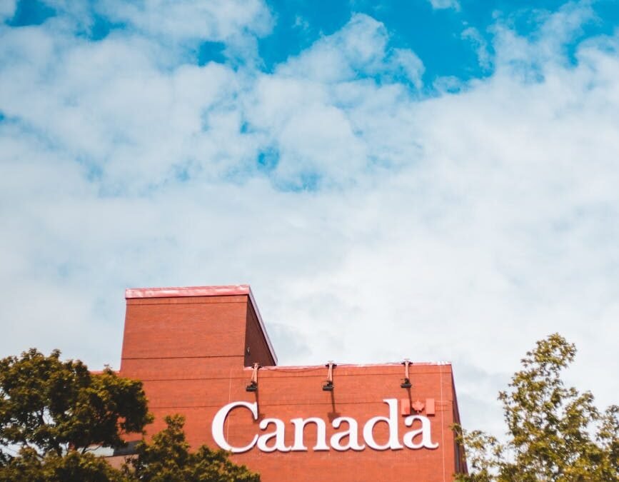 Canada building sign against a blue sky, symbolizing the Canada PR Process.