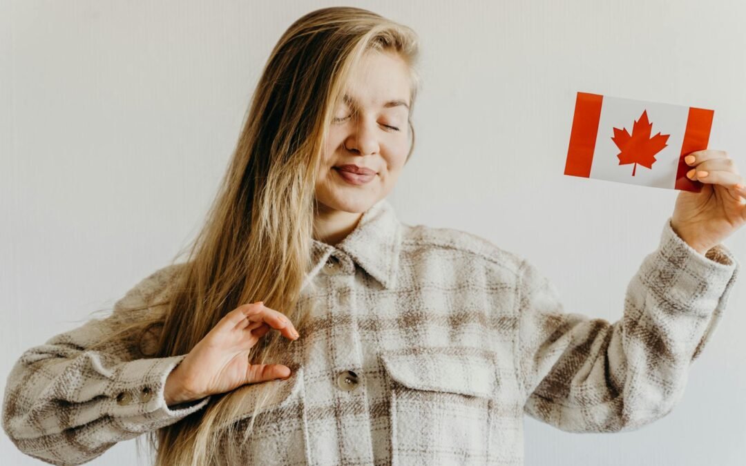 Smiling woman holding a Canadian flag, celebrating Canada PR success.