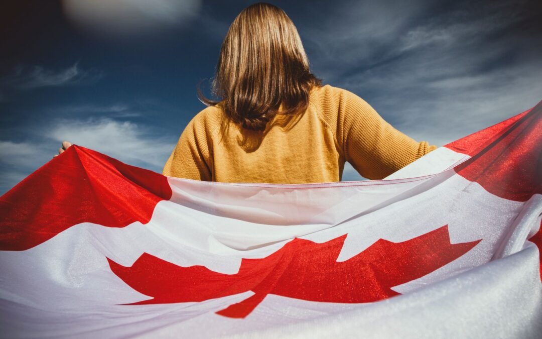 Woman holding a Canadian flag, symbolizing costs of obtaining Canada PR status.