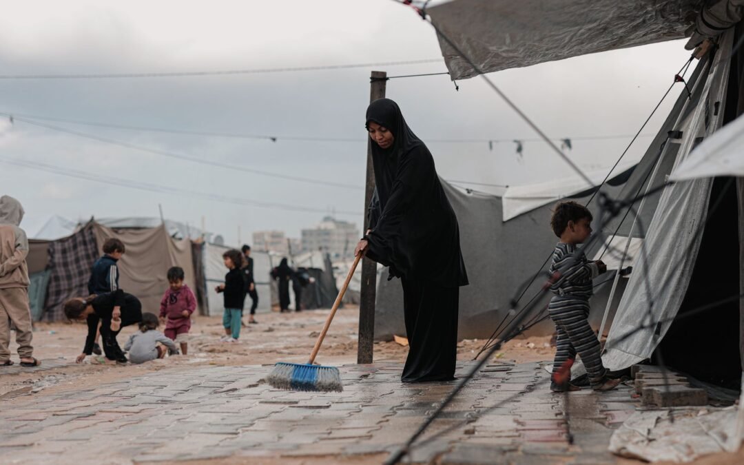 Refugee camp scene highlighting women and children, emphasizing asylum struggles in Canada.
