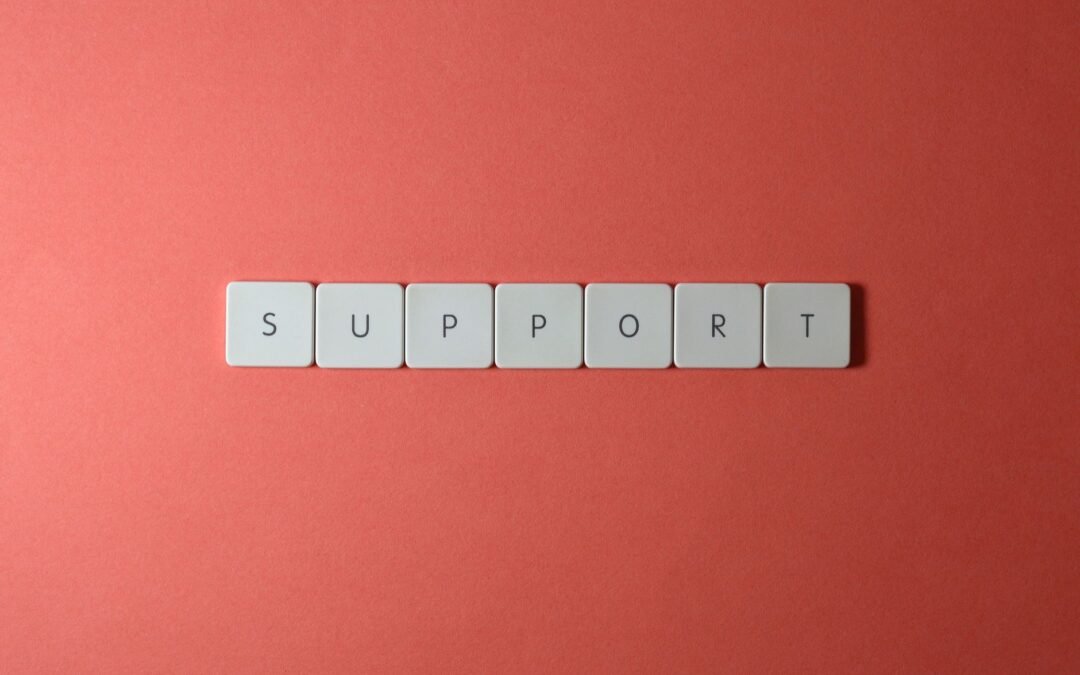 White buttons spelling 'SUPPORT' on a coral background, symbolizing support services.