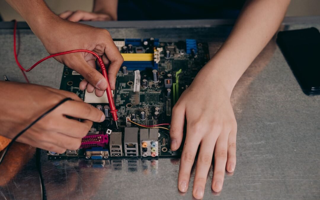 Hands working on a computer motherboard, highlighting essential technical skills in Canada.