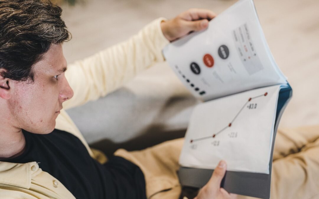 Person reviewing growth metrics and reports for AAIP startup development strategy.